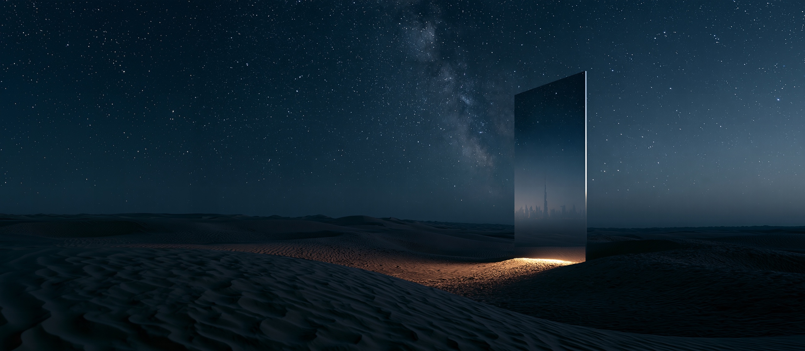 A mirror monolith standing in a vast night desert, a warm city glowing at its base beneath the Milky Way